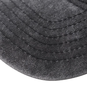 Macro detail of charcoal grey washed cotton baseball cap brim with precise parallel stitching