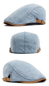 Detail view of washed blue denim flat cap with adjustable brown suede side straps