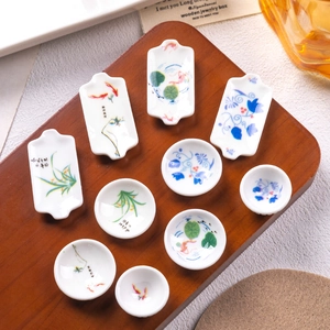 Set of 10 miniature blue and white porcelain plates with koi and floral patterns