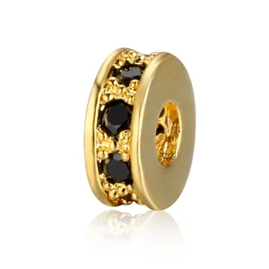 Macro shot of gold-plated spacer bead with micro-paved black zircon stones for DIY jewelry
