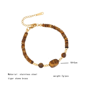 Detail of tiger eye bead bracelet with gold accents and stainless steel clasp specs