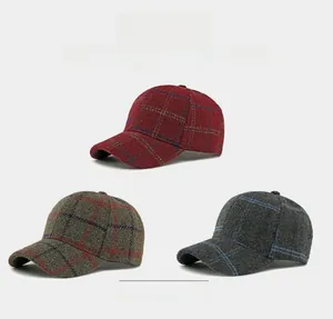 Close-up of thick plaid wool textures in red, olive and grey on vintage baseball caps