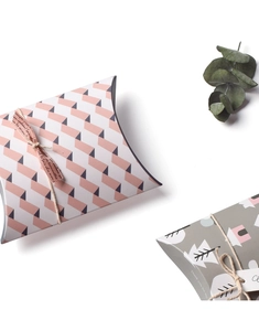 Mini pillow-shaped gift boxes with pink ribbon and grey house patterns on white background