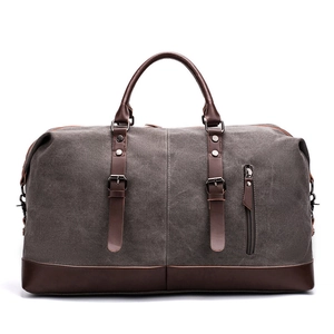 Large capacity grey canvas travel bag with brown leather handles and shoulder strap