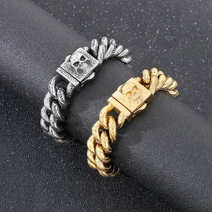 Close-up of punk style skull cuban link bracelet on a dark cylindrical display stand