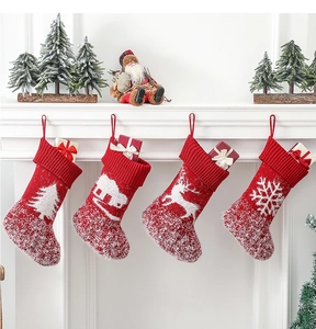Festive knitted Christmas stockings with plush trim hanging on a white mantel with gifts