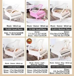 Detailed size comparison of pink and white piano music boxes with ballerina figurines