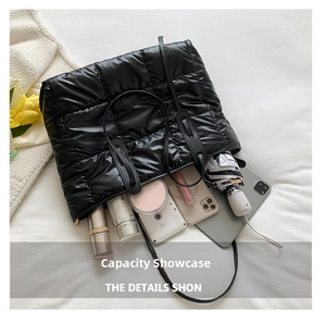 Top view of large black quilted puffer bag showing spacious interior with personal items