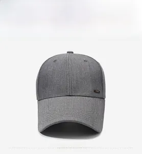 Close-up of a dark grey baseball cap with a textured fabric and a black fashion label