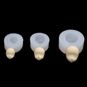 Three sizes of silicone face molds for clay dolls shown on a clean black background