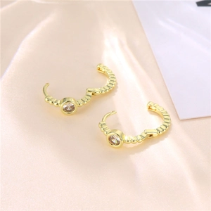 Golden micro-pave zircon hoop earrings with beaded texture on pink silk background