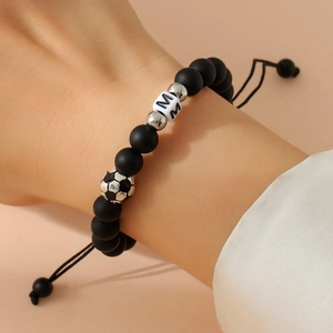 Adjustable matte black bead bracelet with soccer ball and white cube letter M bead