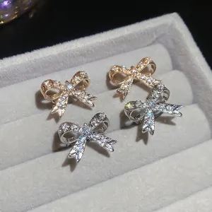 Eleganti ear cuff a fiocco in oro e argento con zirconi in scatola di velluto