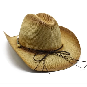 Detail of western straw hat featuring turquoise beads and dark brown cord decoration