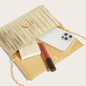 Elegant gold pleated evening clutch bag with chain strap showing spacious interior capacity
