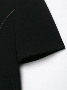 Close-up detail of the sleeve cuff stitching and premium black fabric texture on the blazer