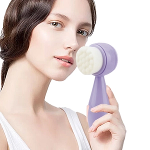 Detail of lavender double-sided silicone facial brush with soft bristles and ergonomic handle
