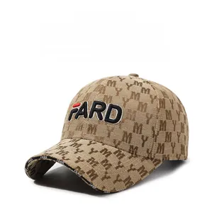 Detail of light brown baseball cap featuring FARD embroidery and MY monogram pattern