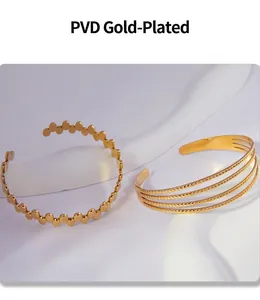 Detail view of gold-plated geometric open bangles with high-shine PVD coating