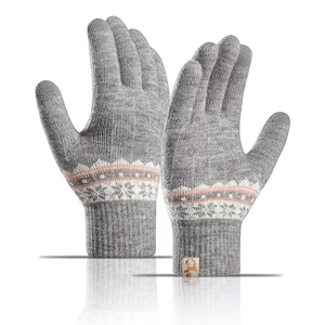 Detail view of grey knitted gloves with geometric patterns and fleece lining cuff