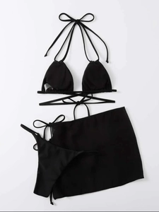 Detailed flat lay of three-piece black bikini set with drawstring ties and mesh cover-up skirt