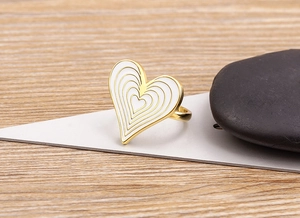 Detailed macro view of 18K gold plated heart ring with white enamel concentric circles