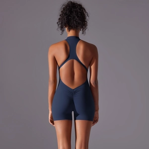 Close-up of deep blue athletic jumpsuit with racerback cutout and ruched butt-lift detail
