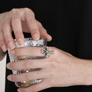Detail of silver Ankh cross ring with vintage engraved texture on male model hand