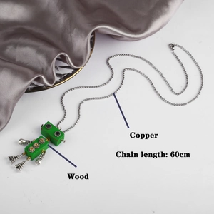 Movable green wooden robot pendant necklace with 60cm copper chain on silk fabric