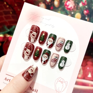 Detailed view of Christmas press-on nails with elk and Santa Claus holiday hand-painted art