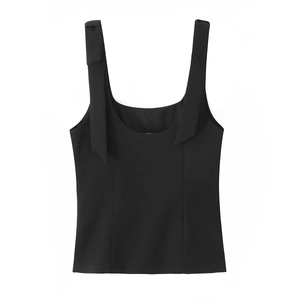 Close-up of black sleeveless top featuring elegant bow detail on shoulder strap