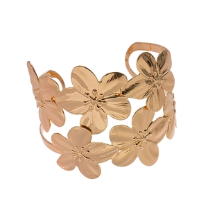 Golden double-layer open cuff bracelet with metallic flowers and brushed textures