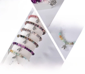 Detail view of 6mm purple agate and pink zebra stone bracelets with ladybug charms
