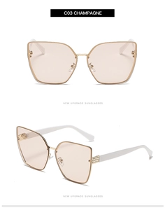 Detail view of champagne cat-eye sunglasses with gold metal frame and diamond-studded temples