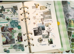 Macro view of a 6-hole binder featuring vintage stickers and fabric grid cover for DIY