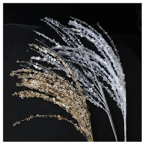 Macro detail of sparkling gold and silver sequin branches for Christmas tree decoration