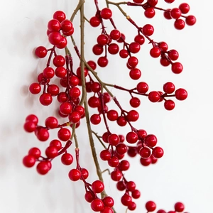 Luxurious artificial red berry branch for festive Christmas home decor on white background