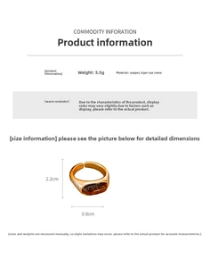 Detail view of oval tiger eye stone on a vintage gold plated ring with measurement data