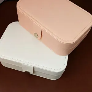 Pink and white PU leather jewelry boxes with snap buttons and elegant stitching details