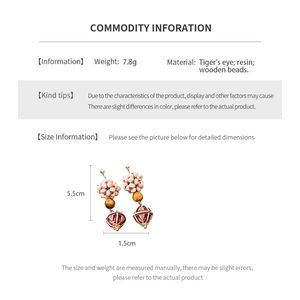 Size and material detail of ethnic bead drop earrings with tiger's eye and wood beads
