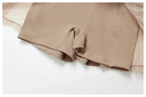 Detail view of skin-colored safety shorts with reinforced stitching and mesh tennis skirt