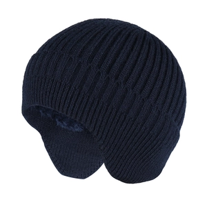 Detail of dark blue knit beanie with soft plush lining and ear flaps for winter warmth