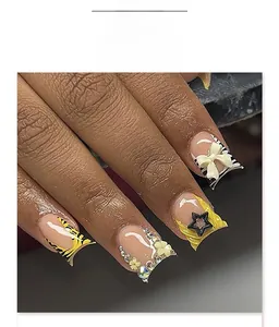 Close-up of square zebra print press-on nails with yellow stars and 3D bow accents