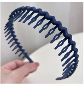 Macro detail of navy blue wavy headband with fine non-slip teeth for secure hair styling