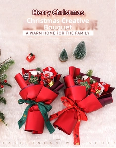 Detailed view of handmade Christmas bouquets with Santa Claus dolls and festive ribbons