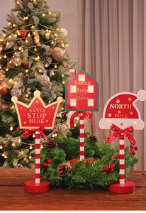 Detail of wooden Christmas STOP signs with LED lights on a festive holiday background