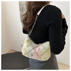 Detail of colorful star checkerboard shoulder bag with frayed edges and silver chain strap