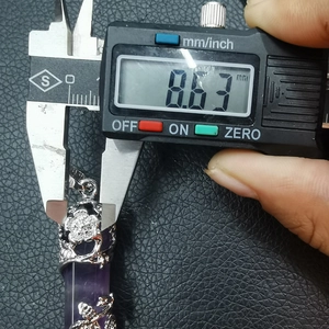 Detailed measurement of the 8.63mm silver floral clasp on a purple crystal pendant