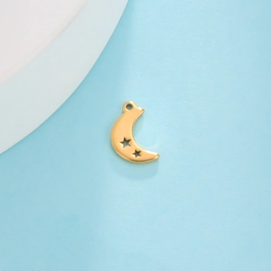 Close-up of golden stainless steel crescent moon pendant with hollow star patterns