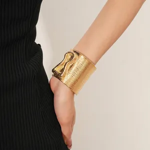 Linear textured gold wide open bangle with unique knot design for women stylish wear
